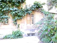 an old building covered in vines and flowers