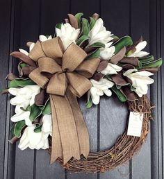 a wreath with white and brown flowers on it