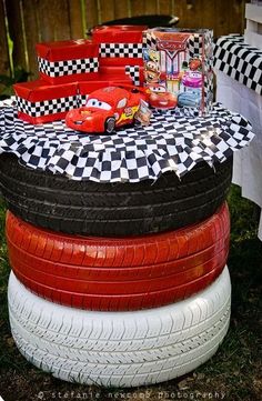 a stack of tires sitting on top of each other in the middle of a yard