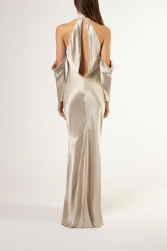 the back of a woman wearing a long dress with an open shoulder and cut out shoulders