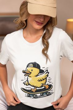 Add a touch of whimsy to your wardrobe with our unisex t-shirt featuring a cute duck riding a skateboard. Perfect for animal lovers and skateboarding enthusiasts, this trendy graphic tee is designed to bring a smile to anyone's face. Made from high-quality, comfortable fabric, this shirt is ideal for casual outings, skate park adventures, or as a unique gift. Show off your fun side with this adorable and eye-catching design. Available in multiple sizes. We utilize the authentic Bella Canvas 3001 Casual Skateboarding Top With Front Print, Casual Tops With Front Print For Skateboarding, Casual Front Print Tops For Skateboarding, Trendy Cotton T-shirt For Skateboarding, Casual White Top For Skateboarding, Hip Hop Screen Print Tops For Skateboarding, White Screen Print Tops For Skateboarding, Casual T-shirt With Graphic Print For Snowboarding, Trendy Crew Neck T-shirt For Skateboarding