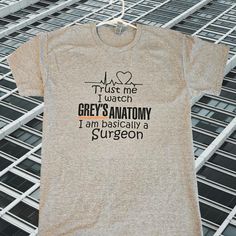 grey's anatomy i am basically a surgeon t - shirt on a metal rack