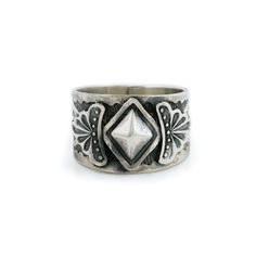 This Navajo silver ring is a stunning and unique piece of jewelry crafted with meticulous attention to detail. The ring is made of high-quality sterling silver and features intricate designs etched into the surface of the metal. The Navajo designs on this ring are both traditional and contemporary. The etched designs are expertly executed with precision and care, creating a delicate and intricate pattern that is both beautiful and meaningful. The ring itself is expertly crafted, with a smooth an Navajo Designs, Navajo Rings, Etched Designs, Polish Silver, Intricate Designs, Silver Band, Rings Statement, Jewelry Crafts, Statement Rings