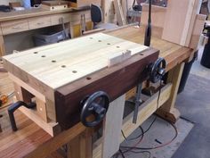 a work bench made out of wooden planks and other woodworking tools in a shop