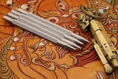 three different types of tools are laying next to each other on a decorative table cloth