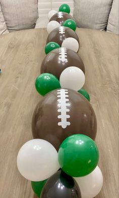 some balloons are lined up in the shape of footballs