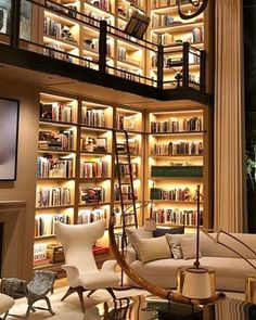 a living room filled with lots of furniture and bookshelves