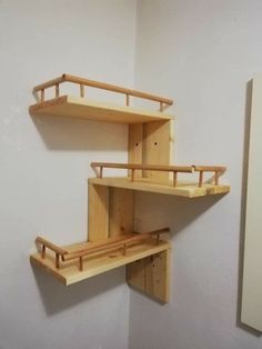 two wooden shelves are on the wall