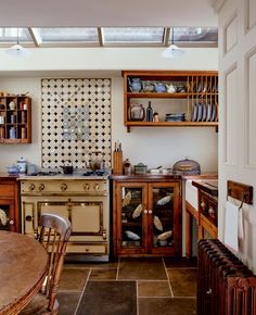 an old fashioned kitchen with wooden cabinets and tile flooring on the walls is shown