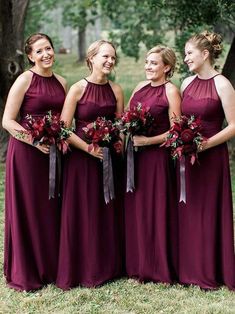 three bridesmaids in maroon dresses standing together