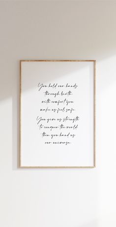 a white wall with a framed quote on it