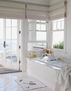 the interior of a house with white walls and flooring, gray paint swatches