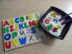 a child's activity book with letters and numbers on it next to a play dough