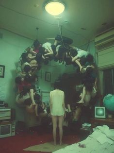 a group of people hanging upside down in a room