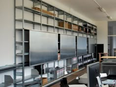 an office with metal shelving and lots of bookshelves