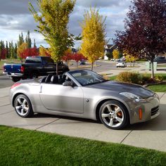 a silver sports car parked in front of a house