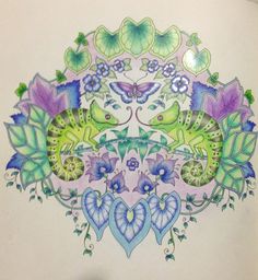 a drawing of flowers and butterflies on a white paper with blue, green and purple colors