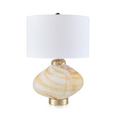 a table lamp with a white shade on the base and a gold - plated metal base