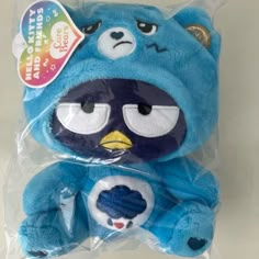 a blue stuffed animal with big eyes and an angry bird on it's chest