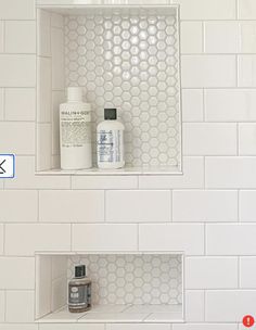 two white shelves with bottles and soaps on them in a bathroom tiled shower wall