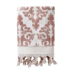 an embroidered towel with tassels hanging from it