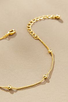 14k gold-plated brass Lobster clasp Imported | Everyday Gold Bracelet by Uncommon James, Women's, Gold/Plated Brass at Anthropologie Classic Gold Beaded Jewelry, Everyday Brass Gold-tone Bracelet, Everyday Gold-tone Brass Bracelet, Dainty Adjustable Tarnish Resistant Chain Bracelet, Minimalist Gold-tone Tarnish Resistant Bracelets, Dainty Adjustable Tarnish-resistant Chain Bracelet, Adjustable 14k Gold Filled Bracelet, Round Gold Bracelet Made Of Brass, Adjustable Gold-tone Bracelet With Delicate Chain