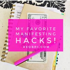 a pink notebook with the words my favorite manfesting hacks next to it