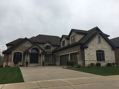 a large house with two car garages on the front and side of it's driveway