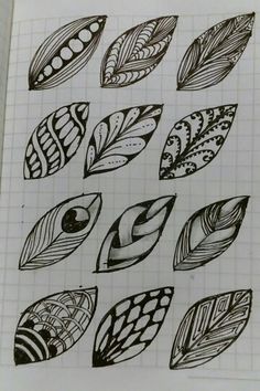 some leaves that are drawn on a piece of paper with pen and ink in it