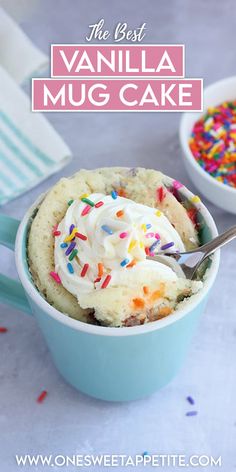 the best vanilla mug cake with sprinkles and whipped cream in a blue bowl