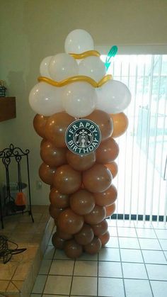 a large balloon sculpture made to look like a starbucks cup