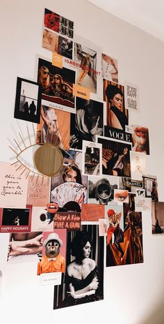 a white wall covered in pictures and magnets with a mirror on top of it