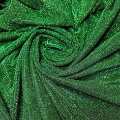 green glitter fabric with lots of small dots on the top and bottom, as if it were