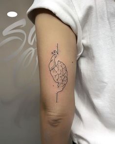 a person with a tattoo on their arm that has a drawing of a human brain