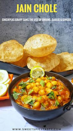 a bowl filled with chickpeas and garnish next to other foods