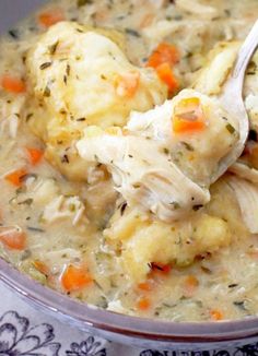 chicken and dumpling soup in a bowl with a spoon