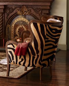 a zebra print chair sitting in front of a fireplace