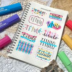 a notebook with some writing on it next to colored markers and crayon pens