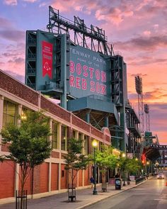 a baseball stadium is lit up at sunset