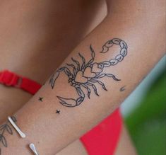 a woman with a crab tattoo on her arm