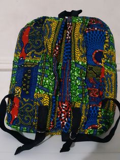 African prints  are best known for their bold, unique and friendly colours.  This backpack  is  handmade. It is  made from Ankara, Kente  (cotton).   It's  big enough for your books,  laptop and other things.      It also has two padded straps which are adjustable, front pocket and zip fastening. Because Kente ((fabric) comes in so many vibrant colour and patterns. There might be slight differences in  fabric pattern and colours of bags. Matching  Earrings, Necklaces, Fascination, Bangles are th Africa Print, Kente Fabric, African Prints, Wax Print, Fabric Pattern, Backpack Purse, Bago, African Print, Matching Earrings