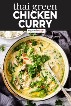 thai chicken curry in a large pot with rice and cilantro on the side