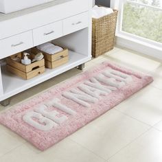 a pink bathroom rug with the word grandma on it