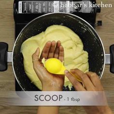 someone is using a yellow spoon to mix batter into a bowl with the word scoop on it