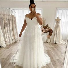 a woman is taking a selfie in her wedding dress while looking into the mirror