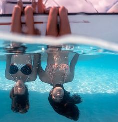 two people are floating in the water with their heads above the water's surface