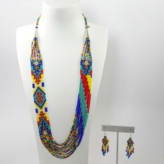 Multiple Strand Glass Bead Necklace with Navajo Rug Design and Sterling Silver Clasp. Necklace is paired with matching french hook dangle earrings. Necklace Length: 28”Necklace Width: 1” Multicolor Southwestern Beaded Necklace With Dangling Beads, Southwestern Style Colorful Beads Dangle Jewelry, Southwestern Style Colorful Beaded Dangle Jewelry, Southwestern Style Dangle Jewelry With Colorful Beads, Multicolor Southwestern Beaded Chain Jewelry, Multicolor Southwestern Style Beaded Chain Jewelry, Southwestern Multicolor Beaded Chain Jewelry, Southwestern Multicolor Beaded Jewelry, Southwestern Style Multicolor Beaded Chain Jewelry