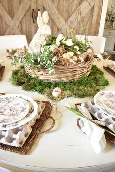 an easter table setting with eggs and flowers