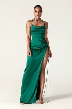 The simple, languid lines of our 'Marlyn' gown make it the perfect choice for Glamorous dinner dates that want something modern yet glamorous. This plunging style is made from liquid silky-satin that skims over your curves and plunging has a leg-baring front slit to emphasize the fluidity of the fabric. The delicate skinny straps prettily at the back to reveal a flowing sweeping train. Twist your hair into a tousled up-do to showcase the elegant open back and crossover straps. This is suitable f Dupioni Silk Dress, Dupioni Silk Fabric, Dress Emerald Green, Backless Maxi Dress, Dupioni Silk, Neckline Dress, Long Maxi Skirts, Backless Maxi Dresses, Cowl Neckline