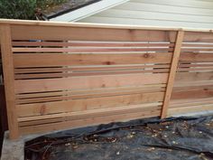 a wooden fence is being constructed in the backyard